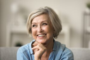 Beautiful senior woman with plump cheeks after facial fat transfer.
