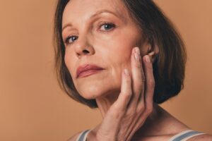 Mature woman with aging skin who may be considering a mini or full facelift.