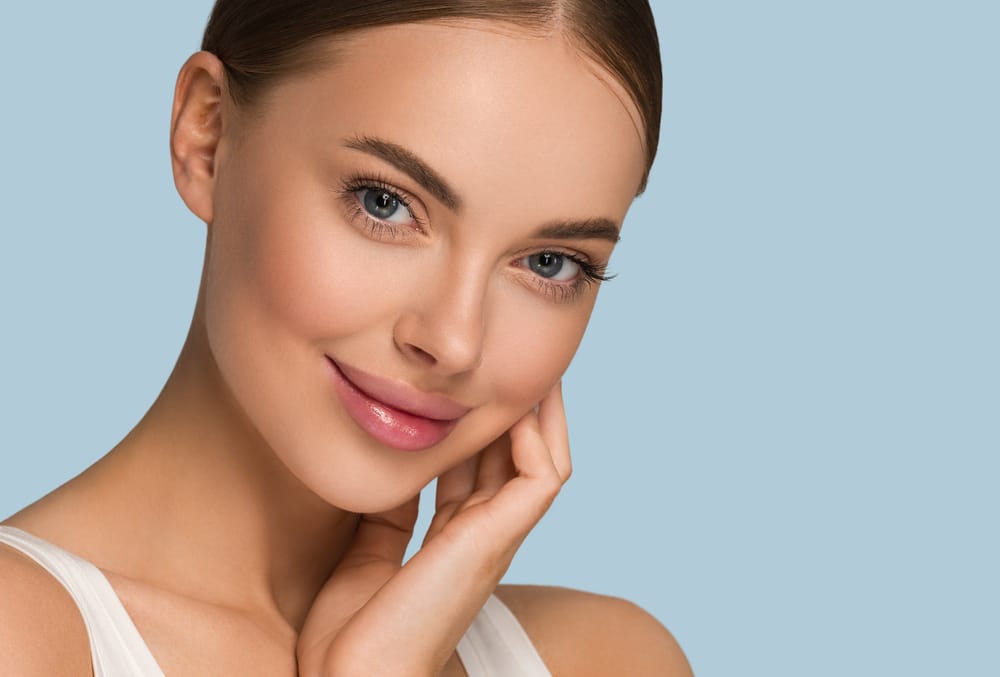 Woman with beautifully enhanced lips after lip augmentation