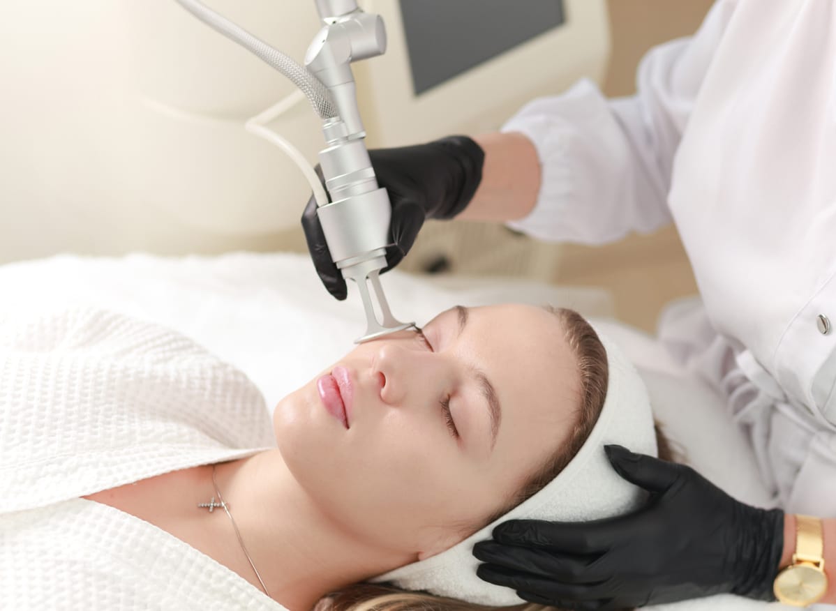 Woman receiving laser skin resurfacing treatment on face